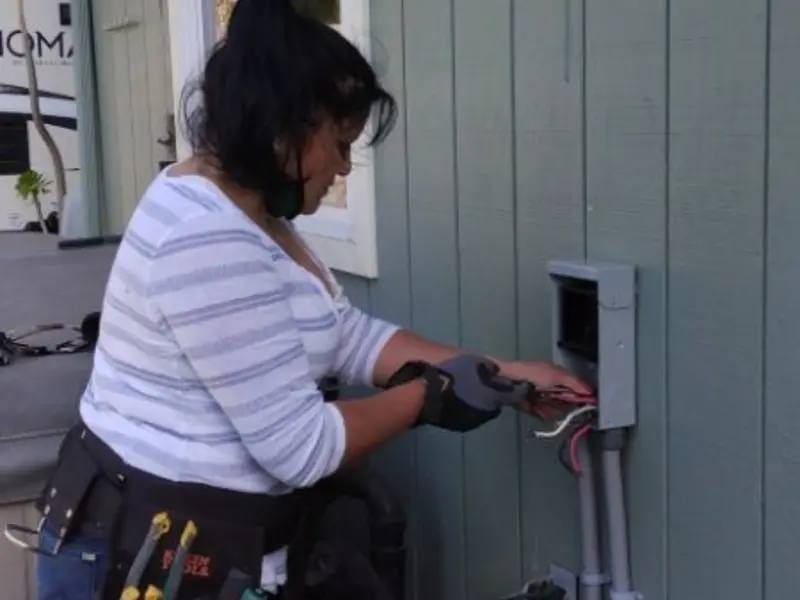Licensed electrician wiring an exterior subpanel in Hempstead